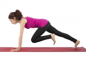 Woman does mountain climber exercise