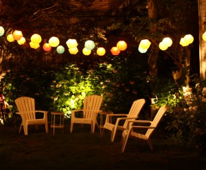 Outdoor lights and muskoka chairs at night