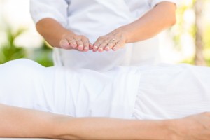 Woman receiving reiki treatment