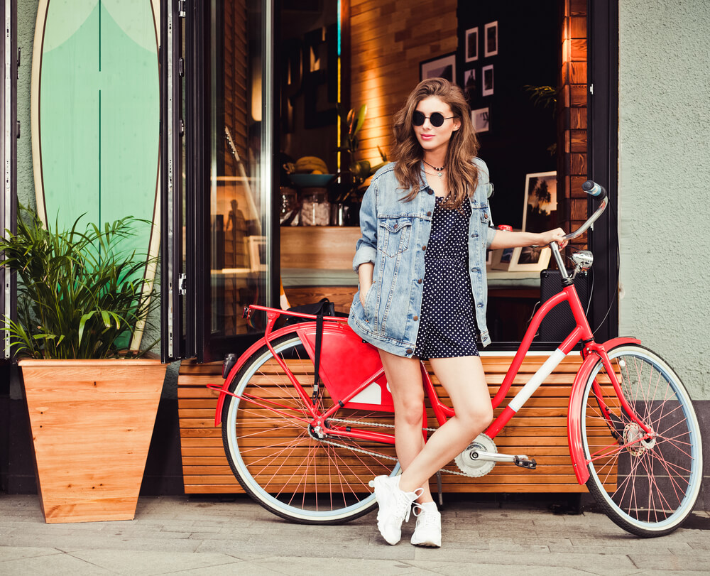 girl in denim jacket outside a cafe