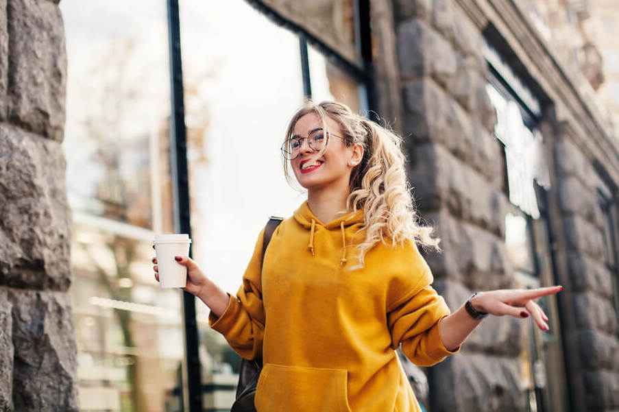 woman in yellow hoodie outdoors