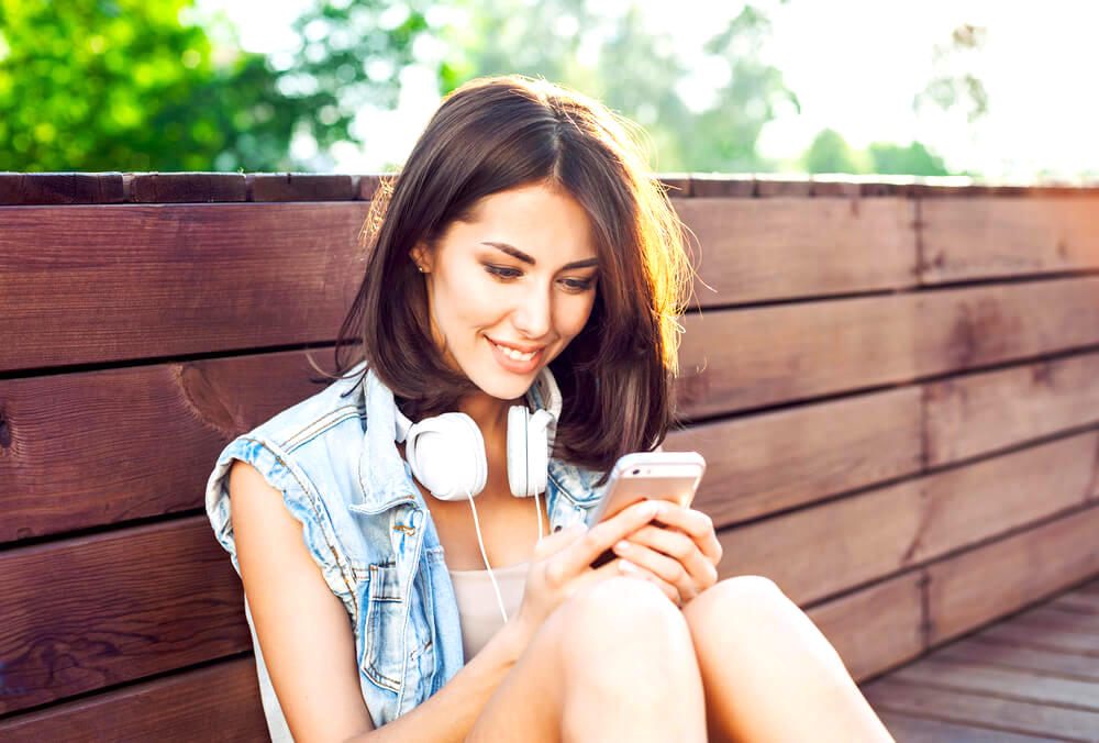 woman typing on phone