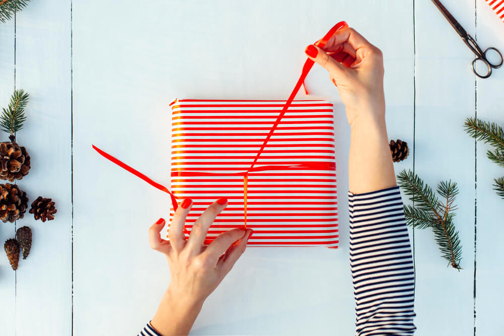 Wrapping gift with red ribbon