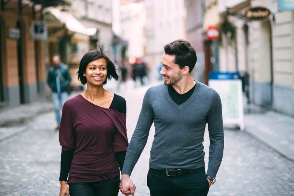 Happy young couple holding hands