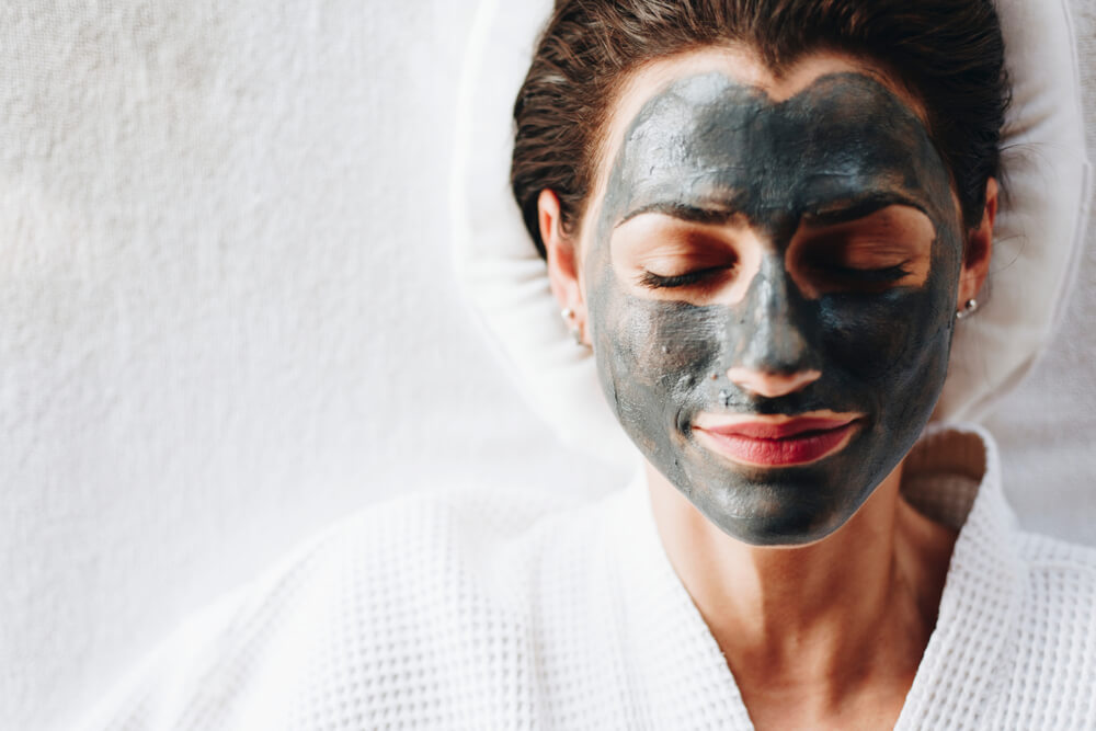 Woman with charcoal face mask