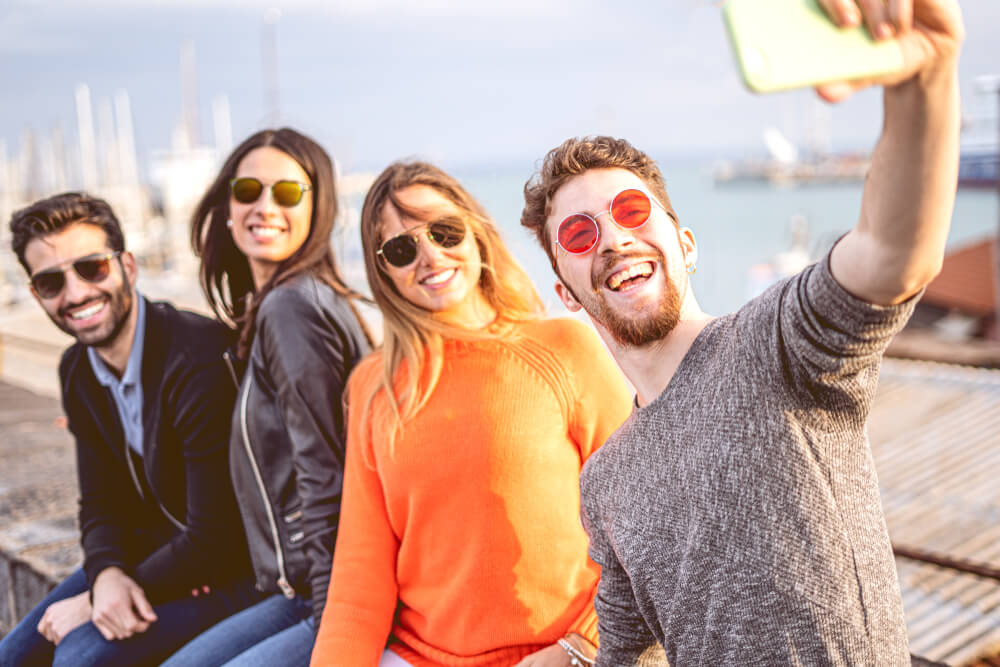 Group of friends taking selfie outdoors