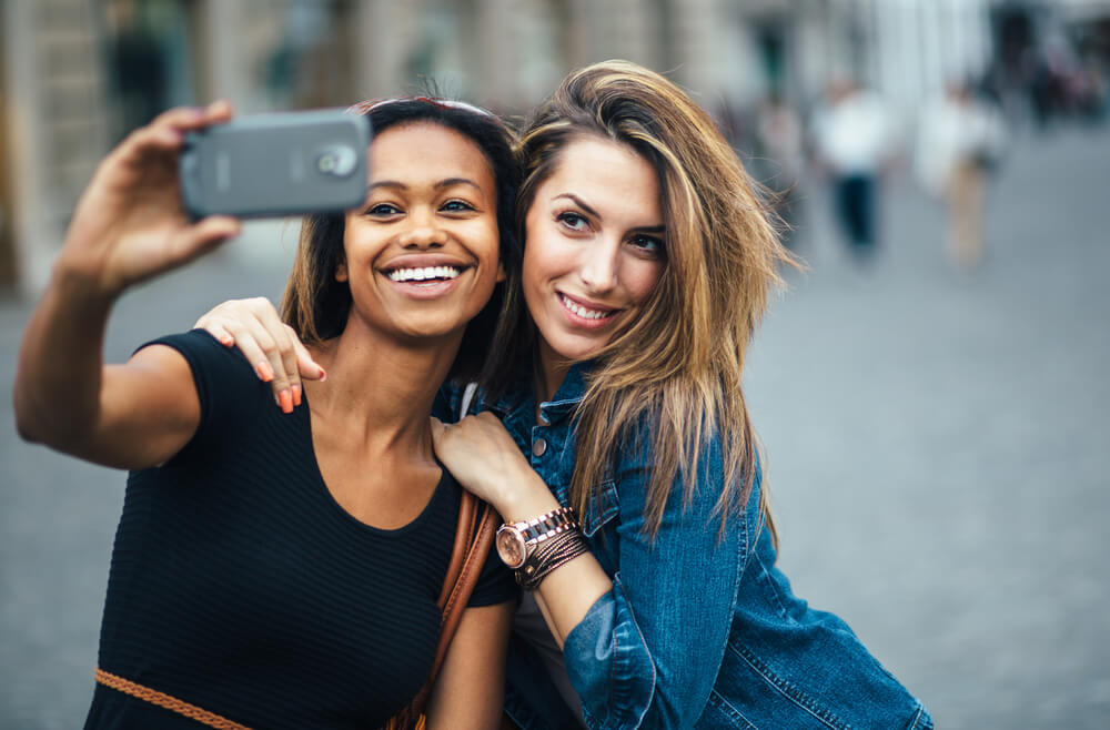 2 female friends taking selfie