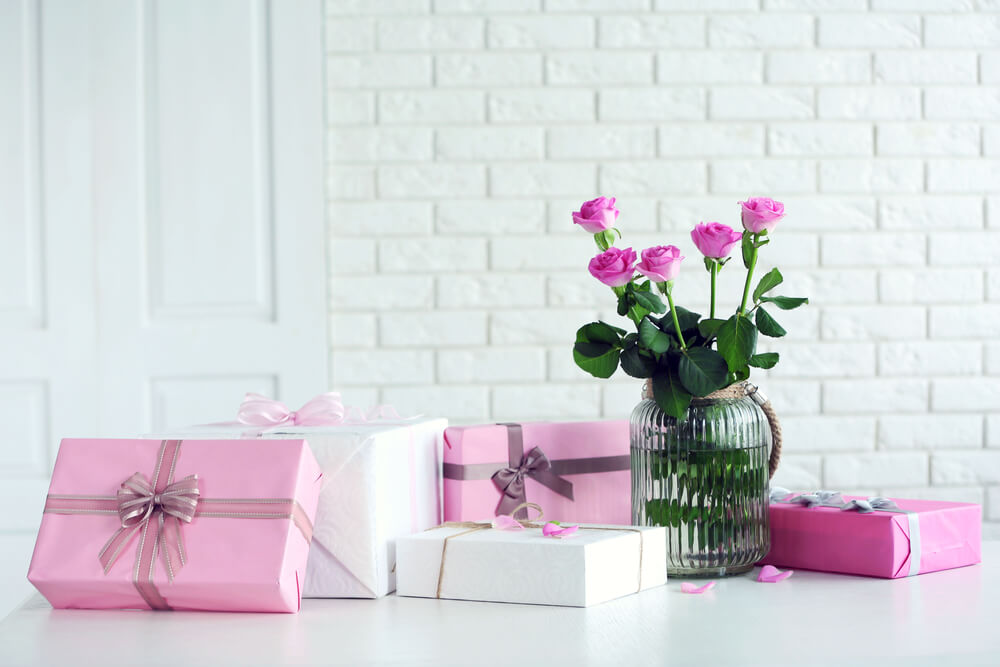 Gifts and flowers on table