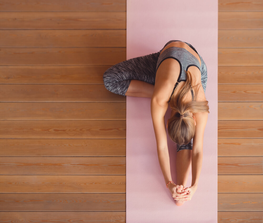 Woman doing yoga on mat