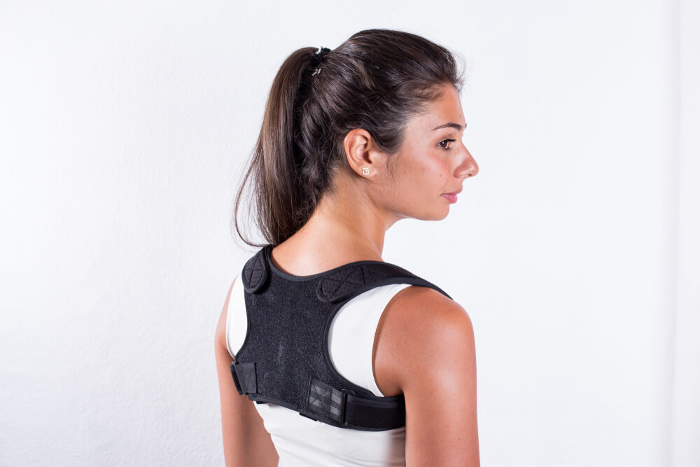 Woman wearing posture support accessory