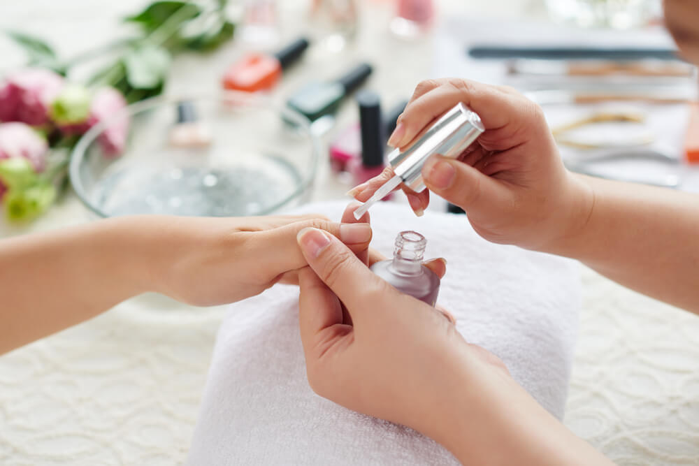 Woman having professional manicure done