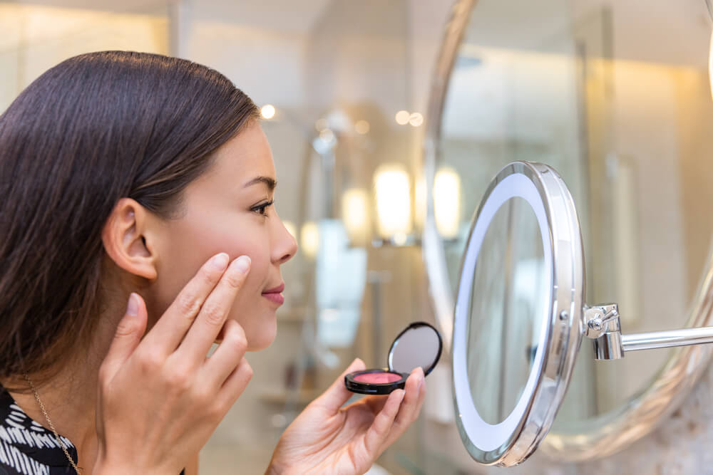 woman applying blush
