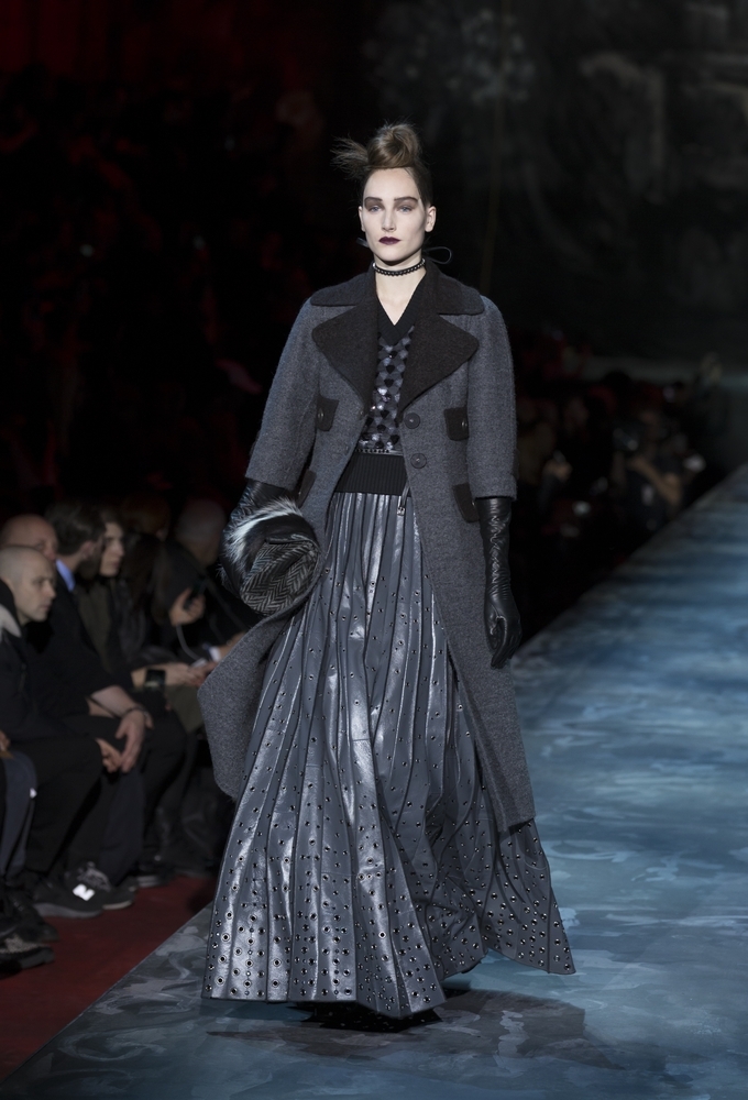 Model walks runway with Victorian-inspired dark colors and long skirt