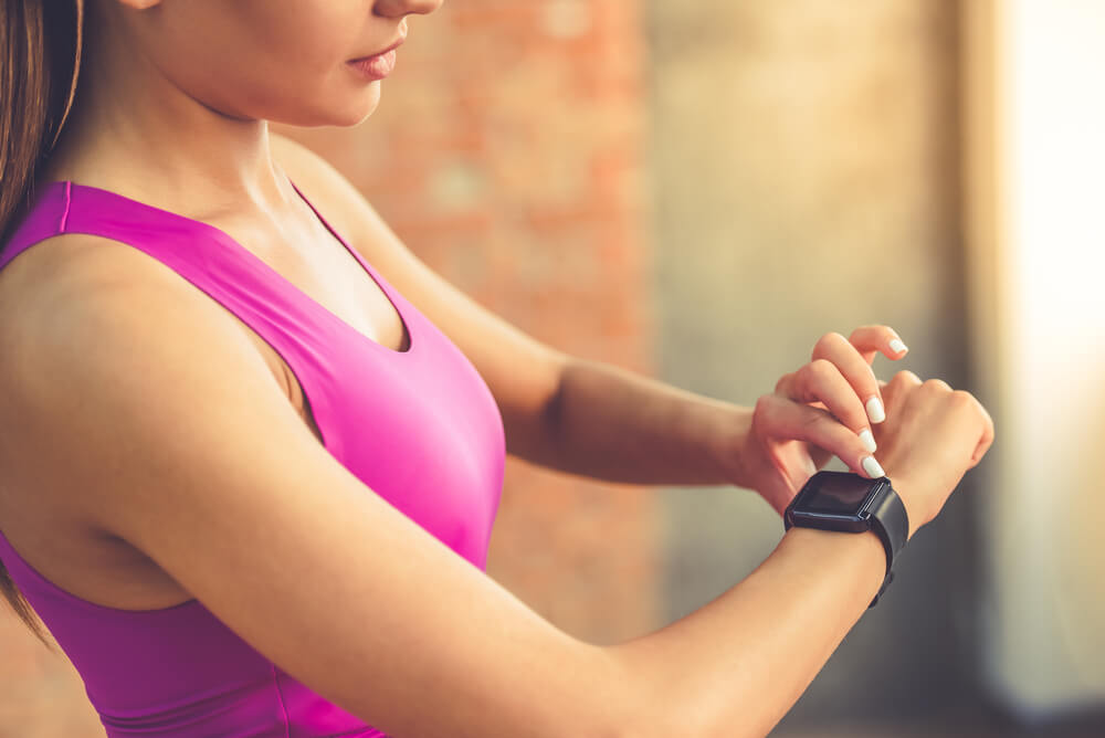 Woman touching fitness watch on wrist