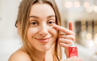 Woman applying eye cream