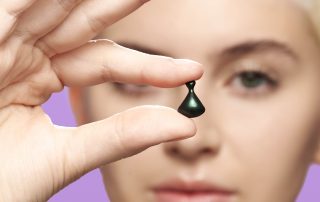 Woman holding Jade Spectra Night Capsule