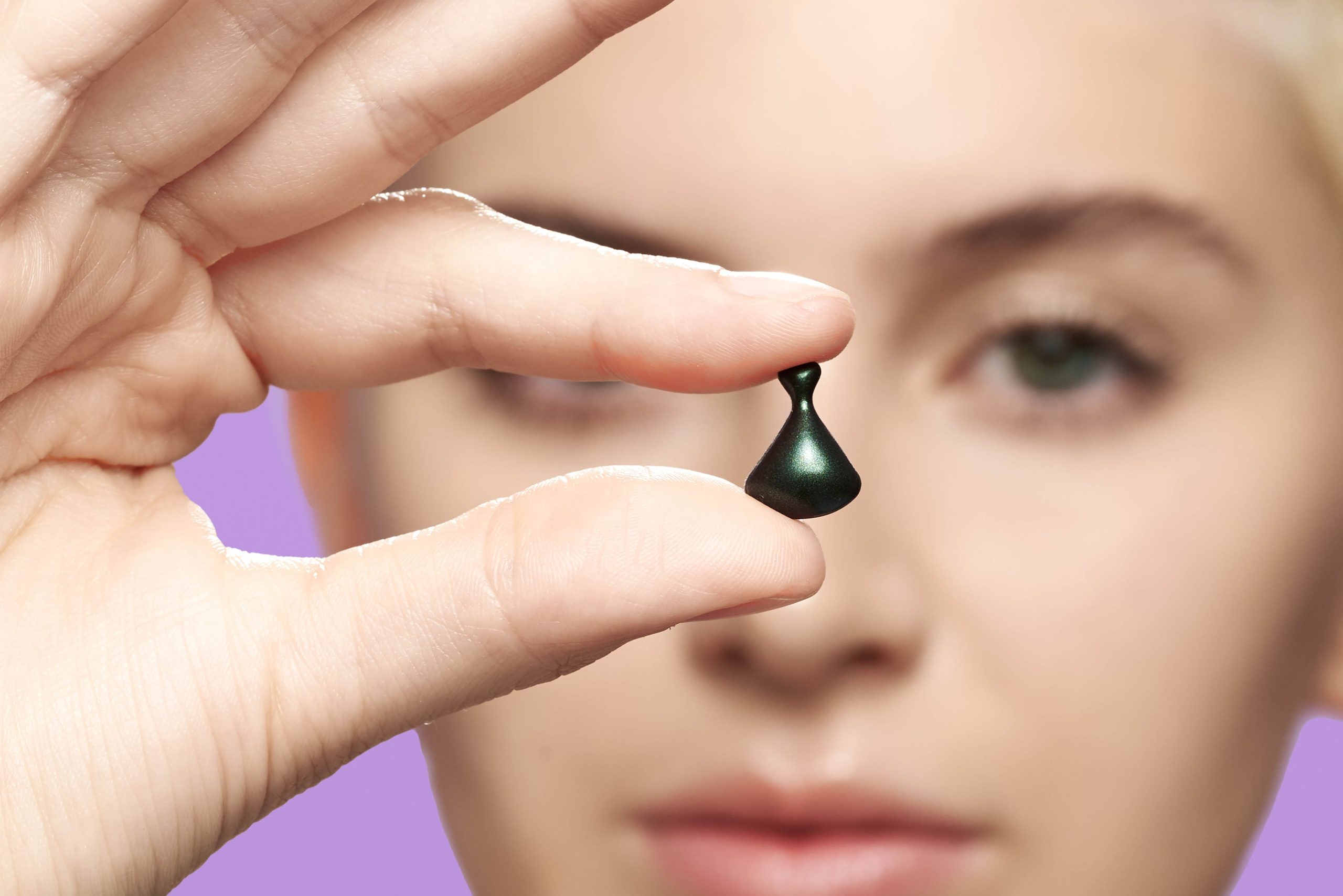 Woman holding Jade Spectra Night Capsule