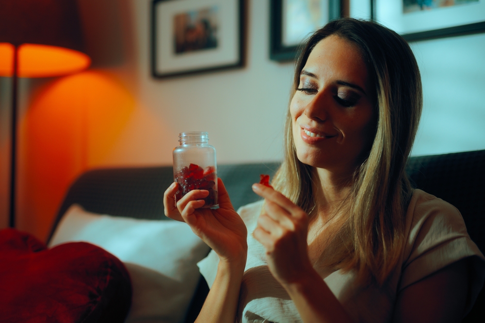 Woman holding retinoid gummy sweet