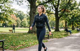 Woman walking in park while wearing a weighted vest